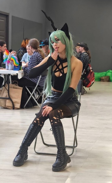 Size: 581x951 | Tagged: safe, artist:hysteriana, derpibooru import, queen chrysalis, changeling, human, boots, breasts, chair, clothes, cosplay, costume, female, festival, goth, hole, holes, horn, humanized, image, irl, irl human, jpeg, leather, leather boots, long hair, open mouth, pentagram, photo, shoes, sitting, skirt, socks, solo, solo female, stockings, thigh highs, tight clothing
