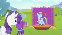 Size: 1920x1080 | Tagged: safe, derpibooru import, screencap, rainbow dash, rarity, butterfly, insect, pegasus, pony, unicorn, may the best pet win, ^^, backdrop, bush, camera, clothes, day, desaturated, duo, eyes closed, female, g4, grass, image, mare, monarch butterfly, outdoors, png, posing for photo, scarf, skis, smiling, tree