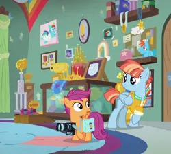 Size: 804x720 | Tagged: safe, derpibooru import, edit, edited screencap, screencap, rainbow dash, scootaloo, windy whistles, pegasus, pony, parental glideance, bag, camera, clothes, cropped, female, filly, foal, freckles, image, jacket, jpeg, looking at each other, looking at someone, mare, saddle bag, smiling, trophy, trophy room