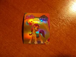 Size: 1024x768 | Tagged: safe, derpibooru import, official, sunny starscout, earth pony, g5, my little pony: a new generation, 3d, cutie mark, image, indonesian, jpeg, logo, looking at you, merchandise, photo, shiny, standing, stars, sticker