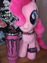 Size: 712x949 | Tagged: safe, artist:casettepony, derpibooru import, pinkie pie, earth pony, original species, plush pony, pony, blue eyes, bracelet, choker, drink, energy drink, front facing, front view, hair over one eye, image, irl, jewelry, jpeg, light switch, monster energy, photo, pink coat, pink mane, plushie, solo, sticker, tumblr, wooden table