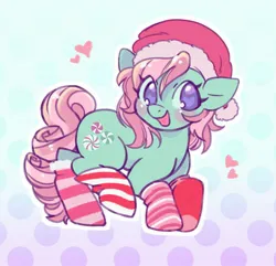 Size: 1627x1566 | Tagged: safe, artist:horseyuris, derpibooru import, minty, earth pony, pony, g3, blushing, cheeks, christmas, clothes, curly mane, curly tail, cutie mark, gradient background, green coat, happy, hat, heart, holiday, image, jpeg, looking at you, pink mane, polka dot background, purple eyes, santa hat, smiling, smiling at you, socks, solo, striped socks, tail