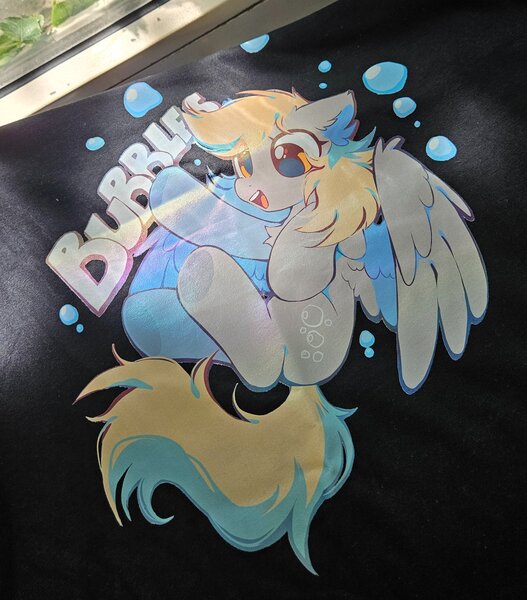 Size: 2653x3019 | Tagged: safe, artist:mirtash, derpibooru import, derpy hooves, pegasus, pony, blonde mane, blonde tail, bubble, chest fluff, countershading, cute, derp, derpabetes, design, ear fluff, eyelashes, female, g4, gray coat, high res, image, in air, irl, jpeg, long mane, long tail, mare, open mouth, open smile, partially open wings, photo, raised hoof, shiny eyes, shirt design, smiling, solo, tail, teeth, text, wing fluff, wingding eyes, wings, yellow eyes
