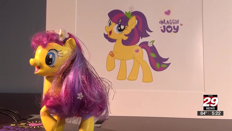 Size: 1280x720 | Tagged: safe, derpibooru import, official, earth pony, bandaid, blue eyes, cute, doll, flower, flower in hair, g4, heart, image, jewelry, jpeg, maggie joy, memory, photo, smiling, standing, tiara, toy