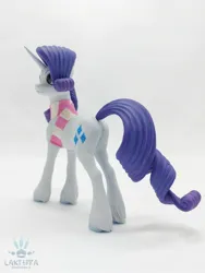 Size: 1620x2160 | Tagged: safe, alternate angle, alternate version, artist:lakterra, derpibooru import, rarity, pony, unicorn, butt, clothes, craft, female, figurine, g4, horn, image, irl, jpeg, mare, photo, plot, polymer clay, scarf, signature, simple background, smiling, solo, striped scarf, tail, unshorn fetlocks, white background