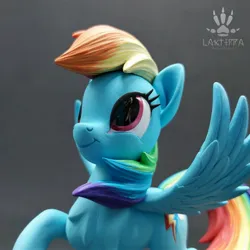 Size: 2560x2560 | Tagged: safe, artist:lakterra, derpibooru import, rainbow dash, pegasus, pony, close-up, craft, female, figurine, g4, image, irl, jpeg, looking up, mare, photo, polymer clay, raised hoof, signature, smiling, solo, spread wings, tail, wings