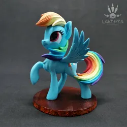 Size: 2560x2560 | Tagged: safe, alternate angle, alternate version, artist:lakterra, derpibooru import, rainbow dash, pegasus, pony, craft, female, figurine, g4, image, irl, jpeg, looking up, mare, photo, polymer clay, raised hoof, signature, smiling, solo, spread wings, stand, tail, wings