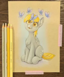 Size: 2114x2537 | Tagged: safe, artist:taytinabelle, derpibooru import, derpy hooves, butterfly, insect, pegasus, pony, :3, :p, chest fluff, colored pencil drawing, colored pencils, cute, ear fluff, female, folded wings, g4, image, irl, jpeg, looking at you, mare, photo, simple background, sitting, smiling, solo, tongue out, traditional art, wings