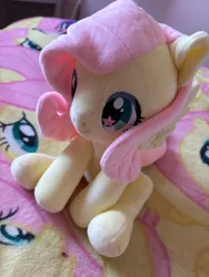 Size: 1500x2000 | Tagged: artist needed, safe, derpibooru import, fluttershy, pegasus, pony, blanket, craft, cute, female, image, irl, mare, merchandise, photo, plushie, png, shyabetes, sitting, smiling, solo, spread wings, starry eyes, wingding eyes, wings