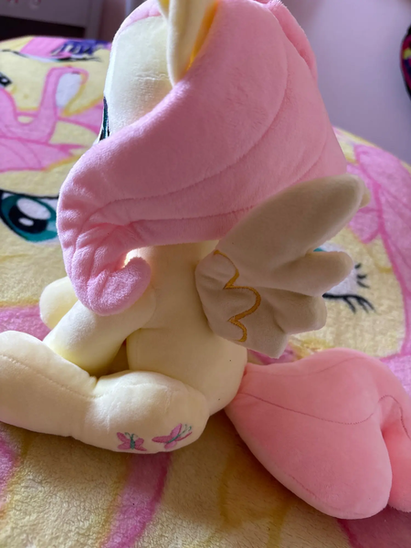 Size: 1500x2000 | Tagged: artist needed, safe, derpibooru import, fluttershy, pegasus, pony, blanket, craft, female, image, irl, mare, merchandise, photo, plushie, png, sitting, smiling, solo, spread wings, wings