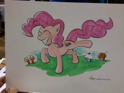 Size: 1024x768 | Tagged: safe, artist:thom zahler, derpibooru import, pinkie pie, earth pony, pony, 2013, commission, cupcake, eyes closed, female, food, g4, grin, image, jpeg, mare, raised hoof, raised leg, signature, smiling, solo, tail, traditional art, wondercon, wondercon 2013