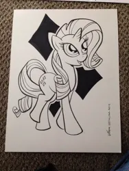 Size: 768x1024 | Tagged: safe, artist:thom zahler, derpibooru import, rarity, pony, unicorn, 2014, black and white, commission, cutie mark background, female, g4, grayscale, heroescon, heroescon 2014, horn, image, irl, irl photo, jpeg, looking up, mare, monochrome, open mouth, open smile, photo, raised leg, signature, smiling, solo, tail, traditional art