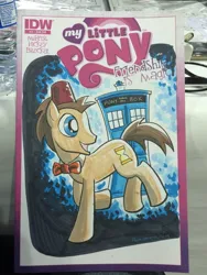 Size: 768x1024 | Tagged: safe, artist:thom zahler, derpibooru import, idw, doctor whooves, time turner, pony, spoiler:comic13, 2014, bowtie, comic cover, commission, cover, cover art, doctor who, fez, g4, grin, hat, image, irl, jpeg, male, my little pony logo, new york comic con, new york comic con 2014, photo, raised hoof, smiling, solo, stallion, tail, tardis, traditional art