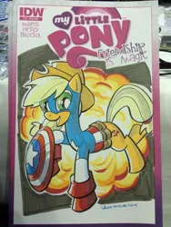 Size: 768x1024 | Tagged: safe, artist:thom zahler, derpibooru import, idw, applejack, earth pony, pony, spoiler:comic13, 2014, applejack's hat, captain america, clothes, comic cover, commission, cosplay, costume, cover, cover art, cowboy hat, crossover, explosion, female, g4, hat, image, irl, jpeg, mare, marvel, my little pony logo, new york comic con, new york comic con 2014, open mouth, open smile, photo, raised hoof, raised leg, shield, signature, smiling, solo, tail, traditional art