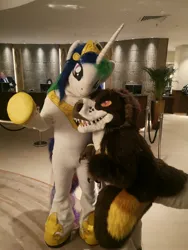 Size: 2976x3968 | Tagged: safe, artist:atalonthedeer, artist:tapewolf, derpibooru import, princess celestia, dinosaur, duo, furry, fursuit, image, indoors, irl, jewelry, jpeg, photo, ponysuit, regalia