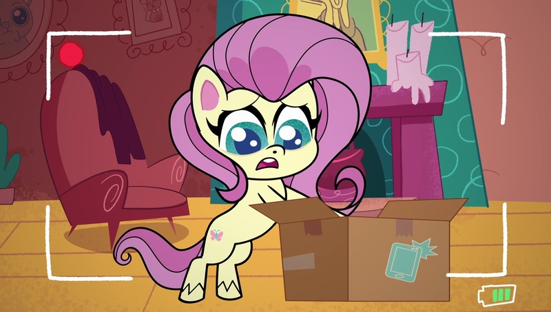 Size: 1920x1088 | Tagged: safe, derpibooru import, screencap, fluttershy, pegasus, pony, g4, my little pony: pony life, unboxing day, spoiler:pony life s01e18, bipedal, box, camera shot, female, image, jpeg, mare, solo