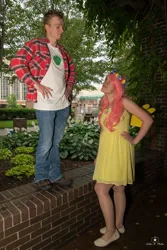 Size: 684x1024 | Tagged: safe, derpibooru import, big macintosh, fluttershy, human, 2015, brick wall, clothes, cosplay, costume, cutie mark, cutie mark on clothes, denim, dress, duo, duo male and female, female, floral head wreath, flower, fluttermac, hand on hip, holding hands, image, irl, jeans, jpeg, looking at each other, looking at someone, male, pants, photo, plaid shirt, shipping, shirt, shoes, straight, t-shirt, tree, wig, wings