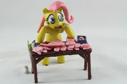 Size: 1280x854 | Tagged: safe, artist:azgchip, derpibooru import, fluttershy, pegasus, pony, g4, bacon, bipedal, bipedal leaning, butcher, butcher knife, cooking, craft, cute, female, food, image, jpeg, knife, leaning, meat, mouth hold, photo, ponies eating meat, pork, sculpture, solo, table, wax