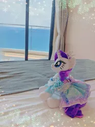 Size: 2781x3735 | Tagged: safe, derpibooru import, rarity, pony, unicorn, clothes, dress, female, horn, image, jewelry, jpeg, mare, necklace, ocean, outfit, photo, plushie, pony plushie, side view, solo, water