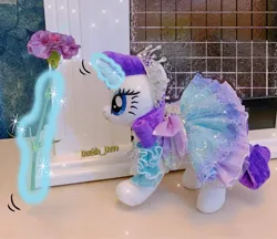 Size: 1500x1298 | Tagged: safe, derpibooru import, rarity, original species, plush pony, pony, unicorn, aura, clothes, dress, flower, glow, glowing horn, hooves, horn, image, jewelry, jpeg, magic, magic aura, necklace, outfit, photo, plushie, raised hoof, solo