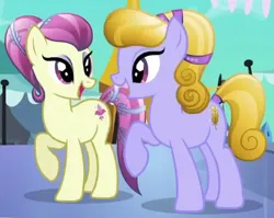 Size: 434x346 | Tagged: safe, derpibooru import, screencap, amber waves, fleur de verre, crystal pony, pony, g4, season 3, the crystal empire, background pony, crystal empire, duo, duo female, eyeshadow, female, image, looking at each other, looking at someone, makeup, mare, open mouth, open smile, png, ponies standing next to each other, raised hoof, smiling, standing