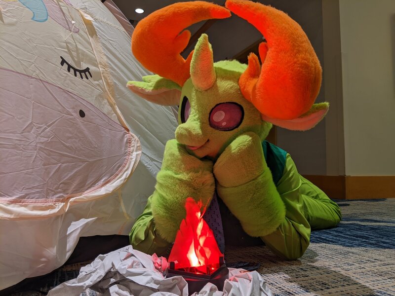 Size: 2048x1536 | Tagged: safe, artist:azuritecoin, artist:limeythecheetah, derpibooru import, changedling, changeling, bonfire, fire, fursuit, hooves on cheeks, image, irl, jpeg, lying down, photo, prone, solo, tent