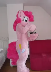 Size: 1138x1608 | Tagged: safe, artist:spainfischer, derpibooru import, pinkie pie, fursuit, hoof hold, image, indoors, irl, photo, png, ponysuit, remote control, solo