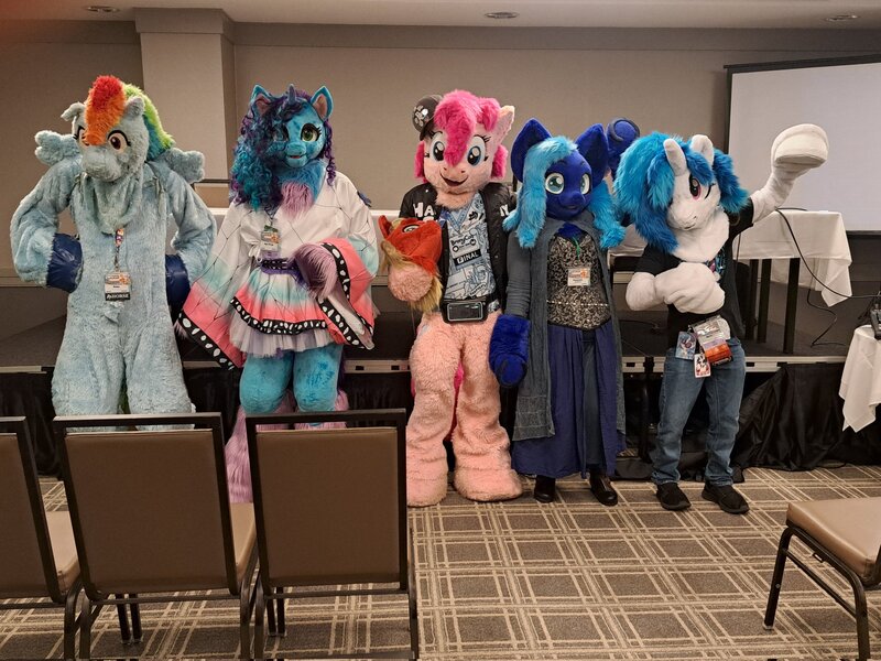 Size: 2048x1536 | Tagged: safe, derpibooru import, pinkie pie, rainbow dash, vinyl scratch, oc, oc:water wings, g5, 2024, fursuit, group photo, image, indoors, irl, jpeg, misty brightdawn, photo, ponysuit, whinny city pony con