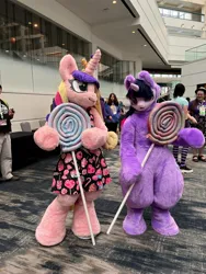 Size: 3024x4032 | Tagged: safe, artist:qtpony, artist:yamakenic, derpibooru import, princess cadance, twilight sparkle, human, 2024, babscon, candy, duo focus, food, fursuit, image, indoors, irl, irl human, jpeg, lollipop, photo, ponysuit