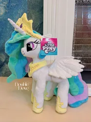 Size: 3178x4238 | Tagged: safe, derpibooru import, official, princess celestia, alicorn, pony, g4, double dove, horn, image, irl, jewelry, jpeg, merchandise, photo, plushie, pony plushie, side view, smiling, solo, standing, text, tiara, wings