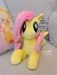 Size: 2552x3402 | Tagged: safe, derpibooru import, official, applejack, fluttershy, pegasus, pony, g4, couch, double dove, image, irl, jpeg, looking at you, lying down, merchandise, photo, pillow, plushie, pony plushie, reesee, smiling, smiling at you, text