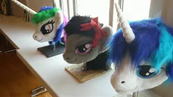 Size: 4128x2322 | Tagged: safe, artist:atalonthedeer, derpibooru import, octavia melody, princess celestia, shining armor, g4, 2013, disembodied head, fursuit head, galacon, image, irl, jpeg, photo, ponysuit, table, trio