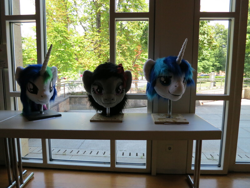 Size: 4000x3000 | Tagged: safe, artist:atalonthedeer, derpibooru import, octavia melody, princess celestia, shining armor, g4, 2013, disembodied head, fursuit head, galacon, image, irl, jpeg, photo, ponysuit, table, trio