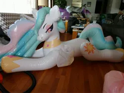 Size: 4000x3000 | Tagged: safe, artist:tico_wolf, derpibooru import, princess celestia, alicorn, inflatable pony, pony, g4, bedroom eyes, deflated wing, female, horseplaytoys, image, indoors, inflatable, inflatable alicorn, inflatable toy, irl, jpeg, looking at you, lying down, mare, photo, side view, solo, three-quarter view, wooden floor